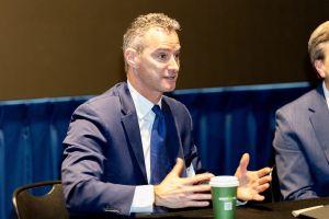 Bakelite President and CEO JP Aucoin speaks while sitting behind a table.