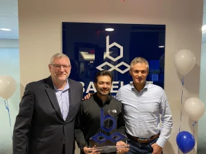 Krunal Shah, Manager, Supply Chain, accepting the Bakelite Fingerprint Award alongside Paul Vogt, EVP & General Manager, Americas (left), and Rafael Morin, Director of Supply Chain (right).